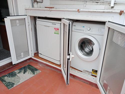 a laundry room with a washer and dryer at Casa Oskar in Avilés