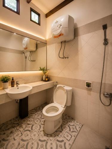 a bathroom with a toilet and a sink at The Haven 3BR Private Pool Lembang in Tegalharendong