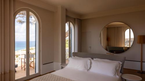 a bedroom with a bed and a view of the ocean at Villa Paola in Tropea