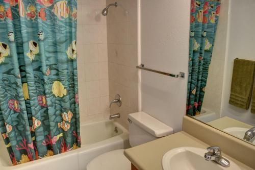 a bathroom with a sink and a toilet and a shower curtain at Maui Vista 3101 in Kihei