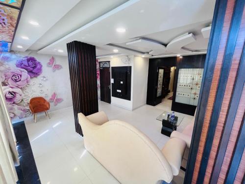 a living room with a white couch and a chair at Hotel The Five Star Inn in Muzaffarpur