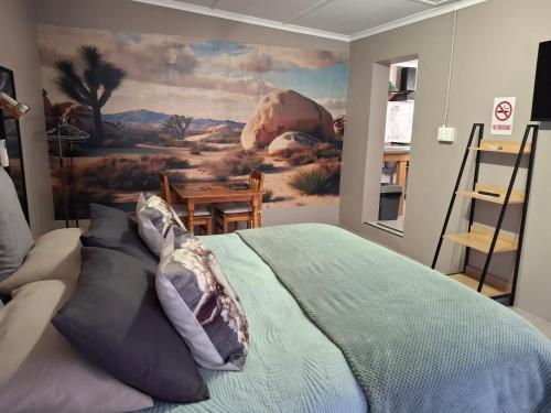 a bedroom with a painting on the wall at 3de laan Springbok in Springbok