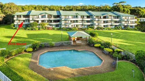 an aerial view of an apartment building with a swimming pool at Fathoms 5 - 2BR beach resort apartment in Mollymook