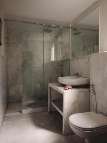 a bathroom with a shower and a toilet and a sink at Longchamps l Zamalek l Boutique Hotel with Breakfast in Cairo