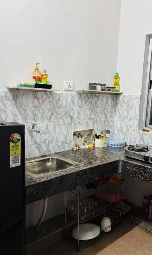 a kitchen with a sink and a counter top at priya inn royal in Lakhīmpur