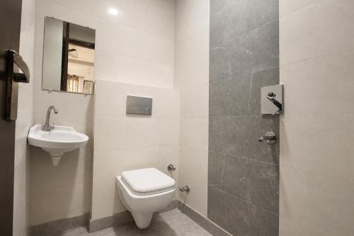 a bathroom with a toilet and a sink at FabHotel Snereya in New Delhi