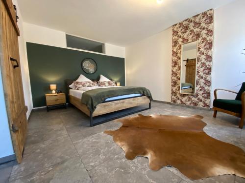 a bedroom with a bed and a table and a mirror at Stodl Living Chiemsee in Grabenstätt