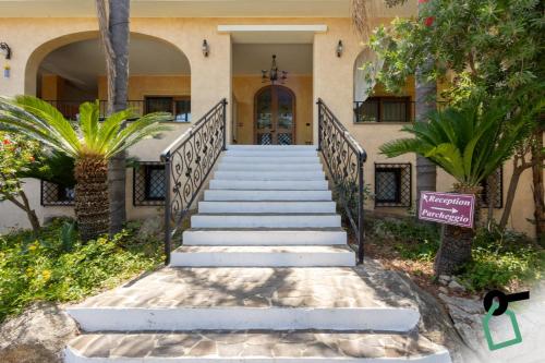 a set of stairs leading to a house with a door at Hotiday Tropea Parghelia in Tropea
