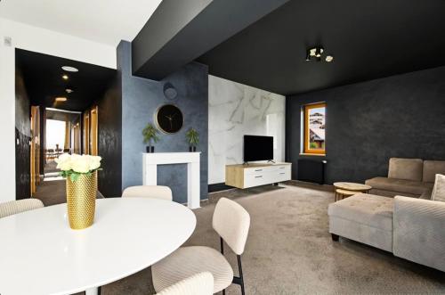 a living room with a white table and a couch at Donovaly Residence Apartment 111 in Donovaly