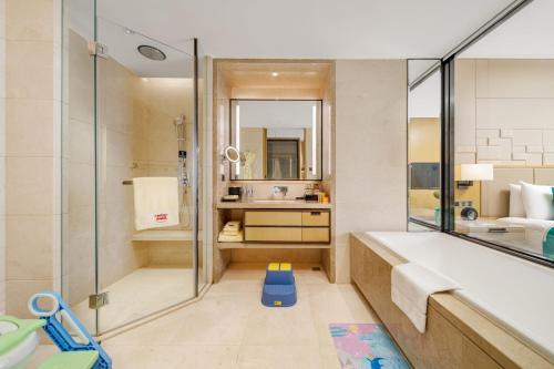 a bathroom with a tub and a sink and a shower at Chengdu Marriott Hotel Financial Centre in Chengdu