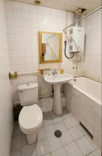 a bathroom with a toilet and a sink and a tub at Arman in Yerevan