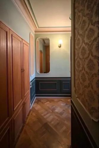 a hallway with a mirror and a wooden floor at Arman in Yerevan