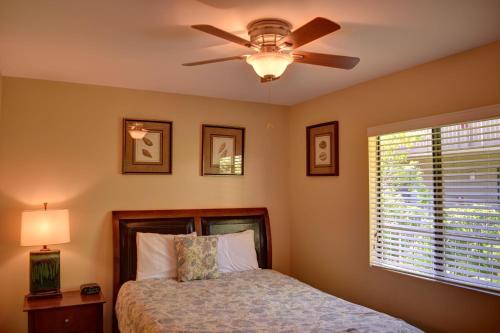 a bedroom with a bed and a ceiling fan at Pacific Shores B303 in Kihei