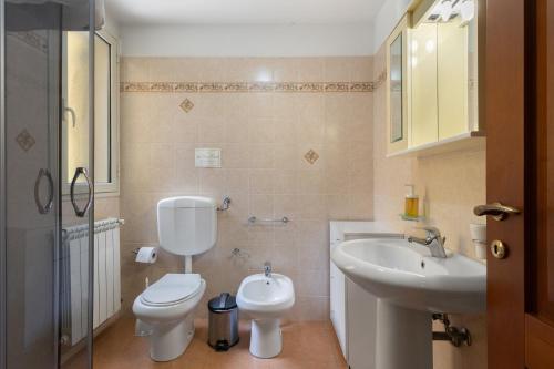 a bathroom with a toilet and a sink at Villa Magda - private pool 20 pax in Marina di Ragusa