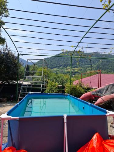 a swimming pool on top of a house at Villa Borjomi in Akhaldaba