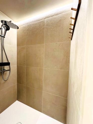 a shower in a bathroom with a shower curtain at Authentic rural square farm in Poperinge