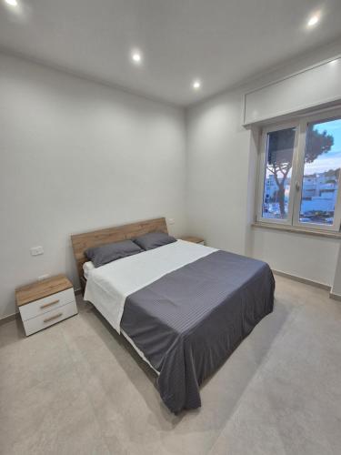 a bedroom with a large bed and a window at Mirabaia in Bacoli