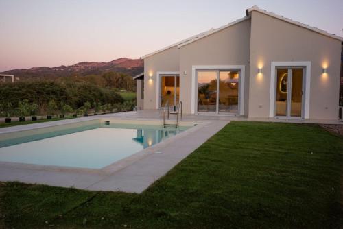 a house with a swimming pool in the yard at Villa Prado in Almiros Beach