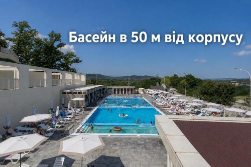 a pool at a hotel with people swimming at SALTERRA Resort in Solotvyno