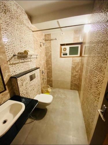 a small bathroom with a sink and a toilet at Hotel Dreamland in Kodaikānāl