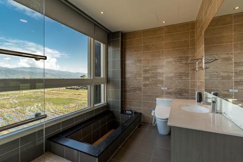 a bathroom with a sink and a large window at 聽風會館 in Yuanshan