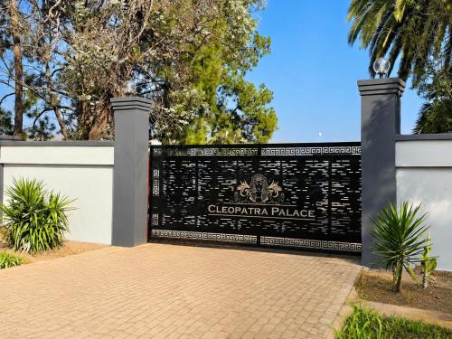 a fence with a sign that reads gibraltar palace at Cleopatra Palace in Vereeniging