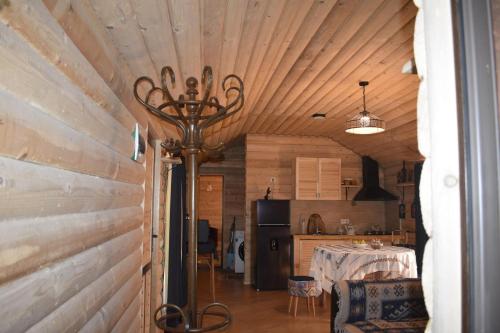 a living room with a table and a kitchen at Keria in Ambrolauri