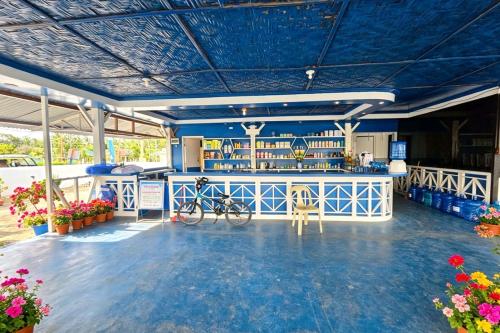 a bar in a building with a blue ceiling at B'lu Bamboo in Moalboal