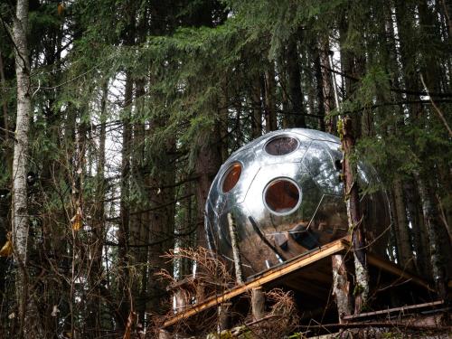 an old train sitting in the woods at Mirror globe Kandasphere in Saint-Gervais-les-Bains