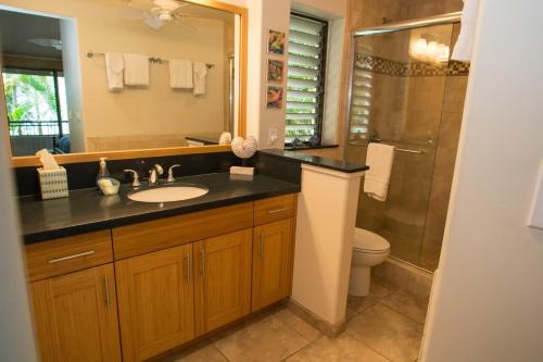 a bathroom with a sink and a toilet and a shower at Wailea Ekolu 1706 in Wailea