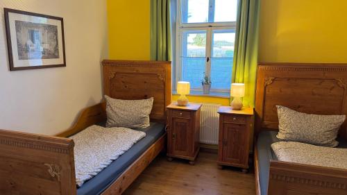 a room with two beds and a window at FeWo Gutendorf in Bad Berka