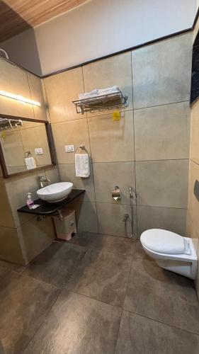 a bathroom with a toilet and a sink at Green View Resorts in Munnar