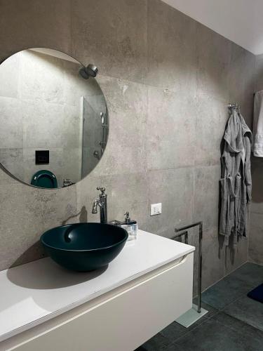 a bathroom with a sink and a mirror on a counter at La Casetta Noble House in Casoli