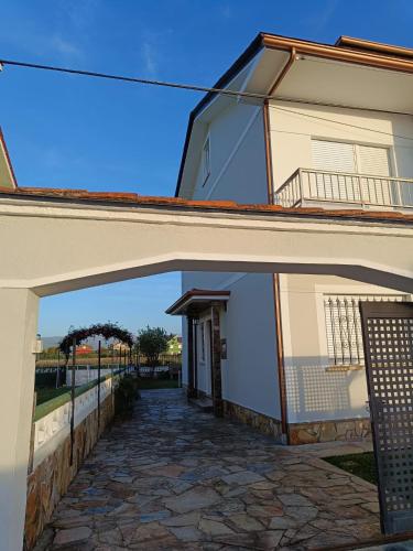 a building with an archway in front of it at A Pedriña Ribadeo in Ribadeo