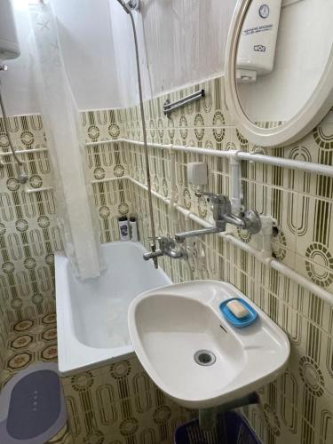 a bathroom with a sink and a mirror at Yellow House in Ritopek