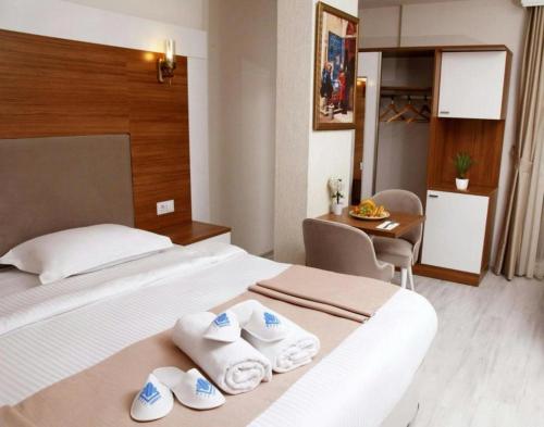 a hotel room with a bed with towels on it at FAVORİTE Hotel in Söğütlü