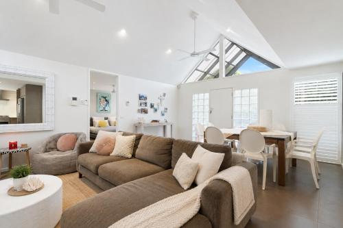 a living room with a couch and a dining room at Kos Place in Blairgowrie by Ready Set Stay in Blairgowrie