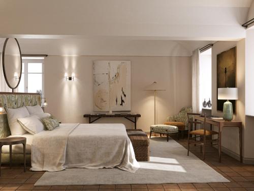 a bedroom with a bed and a table and a desk at BORGO MONCHIERO HERITAGE by Atmosphere in Monchiero
