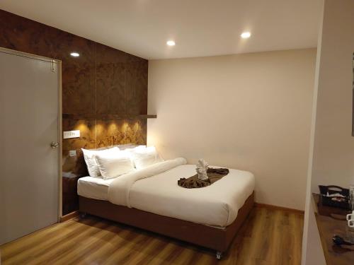 a bedroom with a large bed with white sheets at Heranya Taleju in Kathmandu