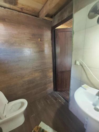 a bathroom with a toilet and a sink at Getaway in Chʼkhakoura