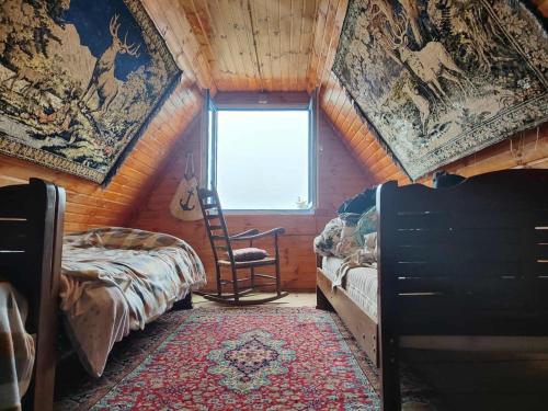 a room with two beds and a window in a room with a ceiling at Getaway in Chʼkhakoura