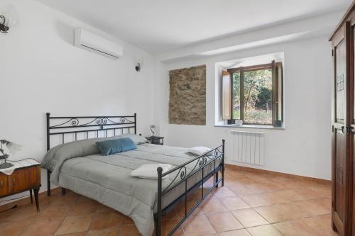 a bedroom with a large bed and a window at Fattoria San Pio in Naso