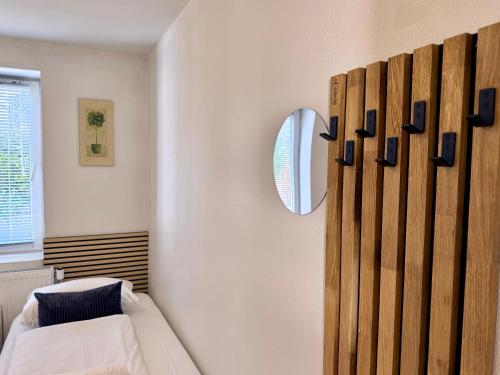a bedroom with a bed and a mirror on the wall at Padborg Inn - Simple Rooms & Modern Apartments in Padborg
