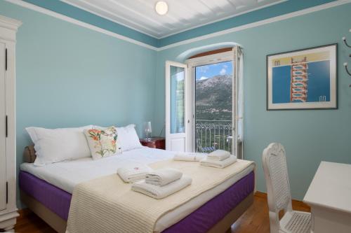 a bedroom with a bed with towels on it at Iconic Villas - Villa Vada in Agia Effimia