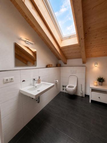 a bathroom with a sink and a toilet at Alpenwohnung Neuner in Wallgau