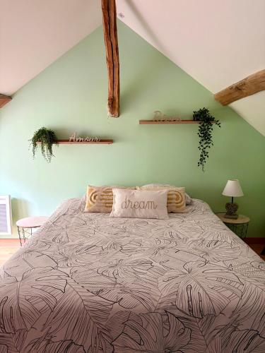 a bedroom with a large bed in a room at Détente aux beaumonts in Chouzy-sur-Cisse