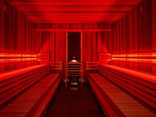 a red auditorium with red benches and a table at ibis Styles Nowy Targ in Nowy Targ
