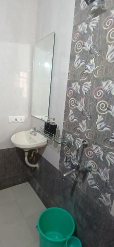 a bathroom with a sink and a mirror at Coastal Gateway Resort in Revadanda