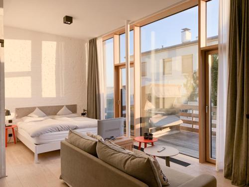 a living room with a bed and a couch at Inselloft Norderney in Norderney