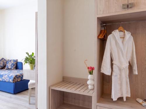 a room with a closet with a robe in it at Hotel Castello Artemide Congressi in Castel San Pietro Terme